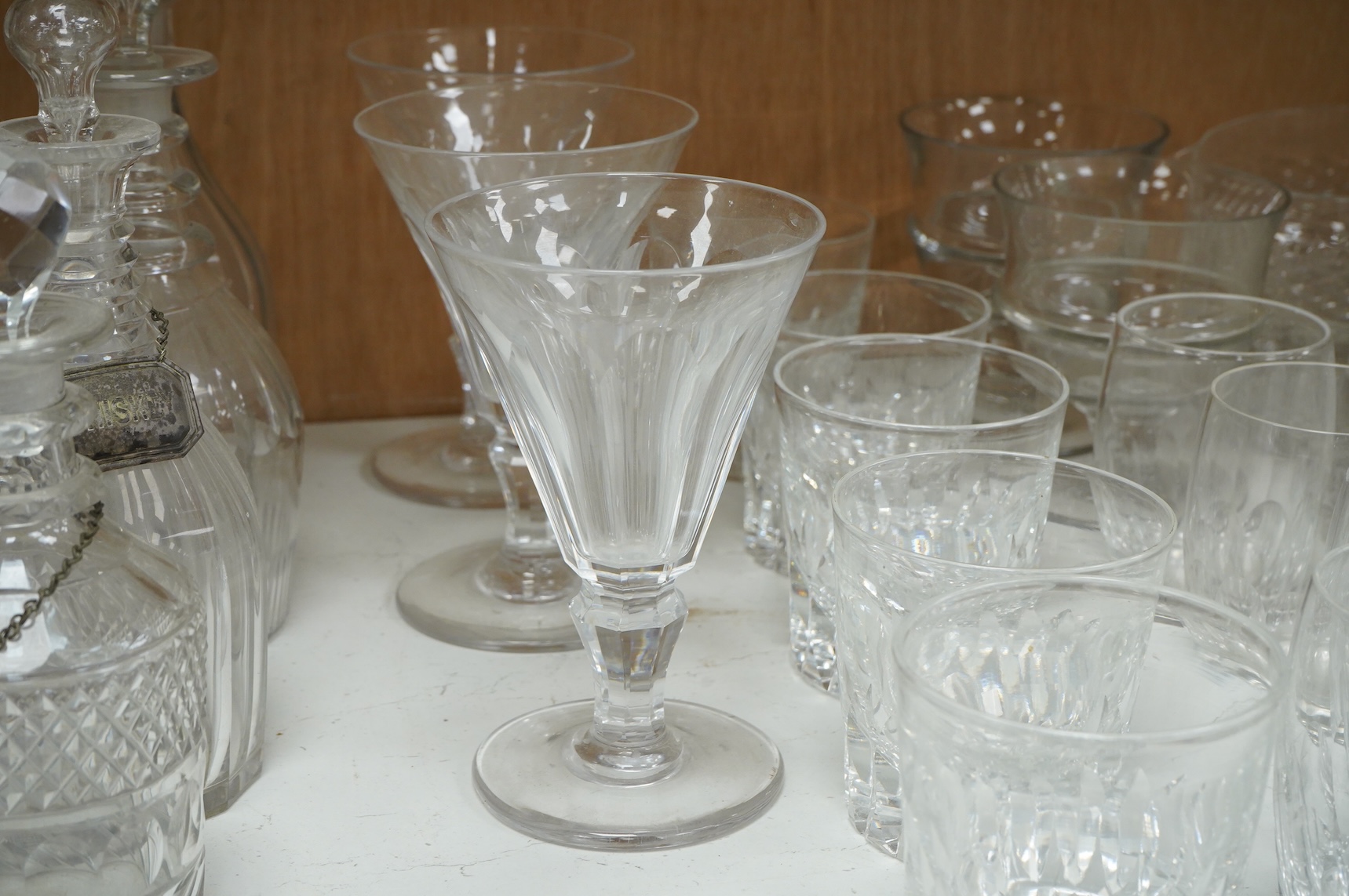 A collection of 19th century and later glassware, to include: Three fluted wine glasses two rummers, various risers and finger bows, decanters etc